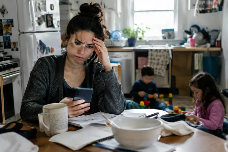 Family budget worksheet beside medical bills and insurance forms